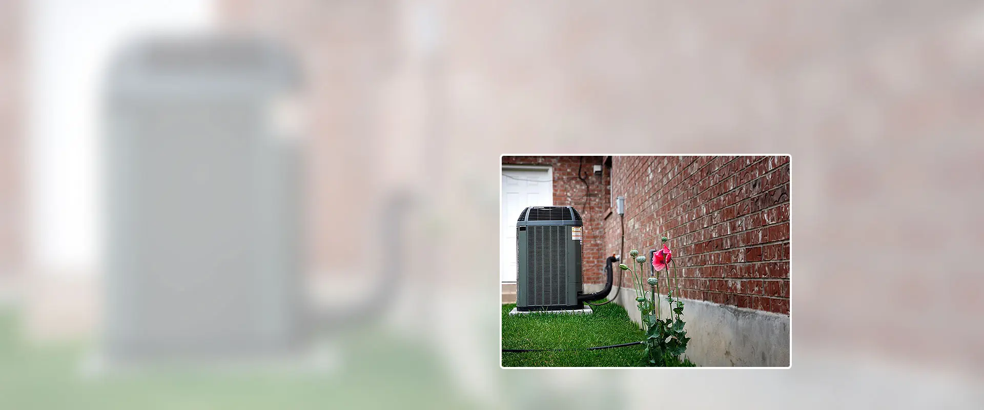 A picture of an air conditioner outside on the grass.